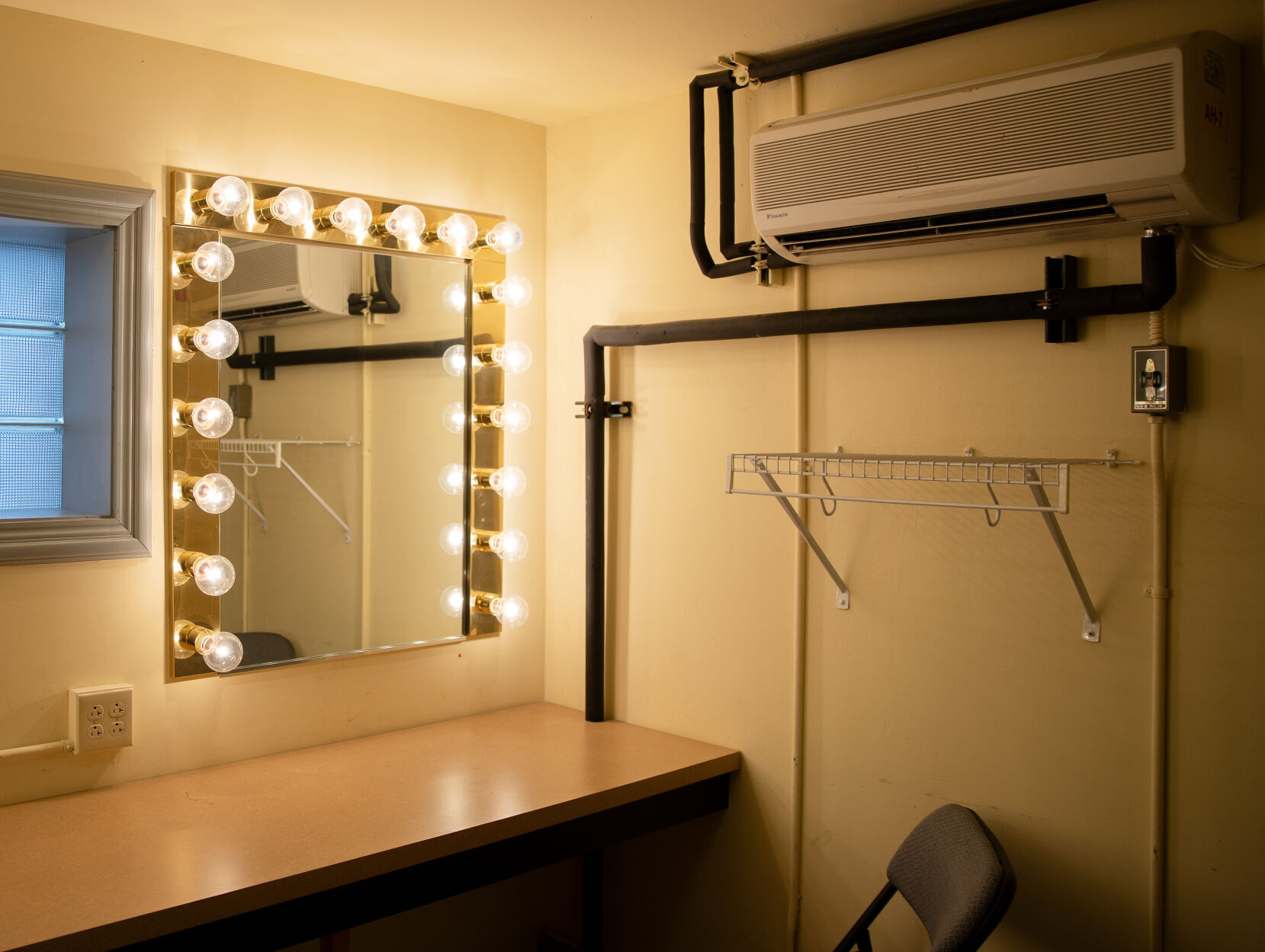A mirror lights up a dressing room